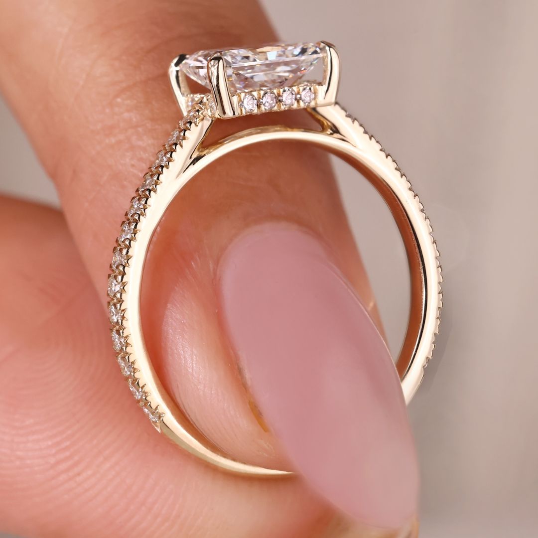 Cathedral setting engagement ring with radiant cut diamond.