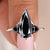 Pear cut moissanite ring with a sleek white gold band.