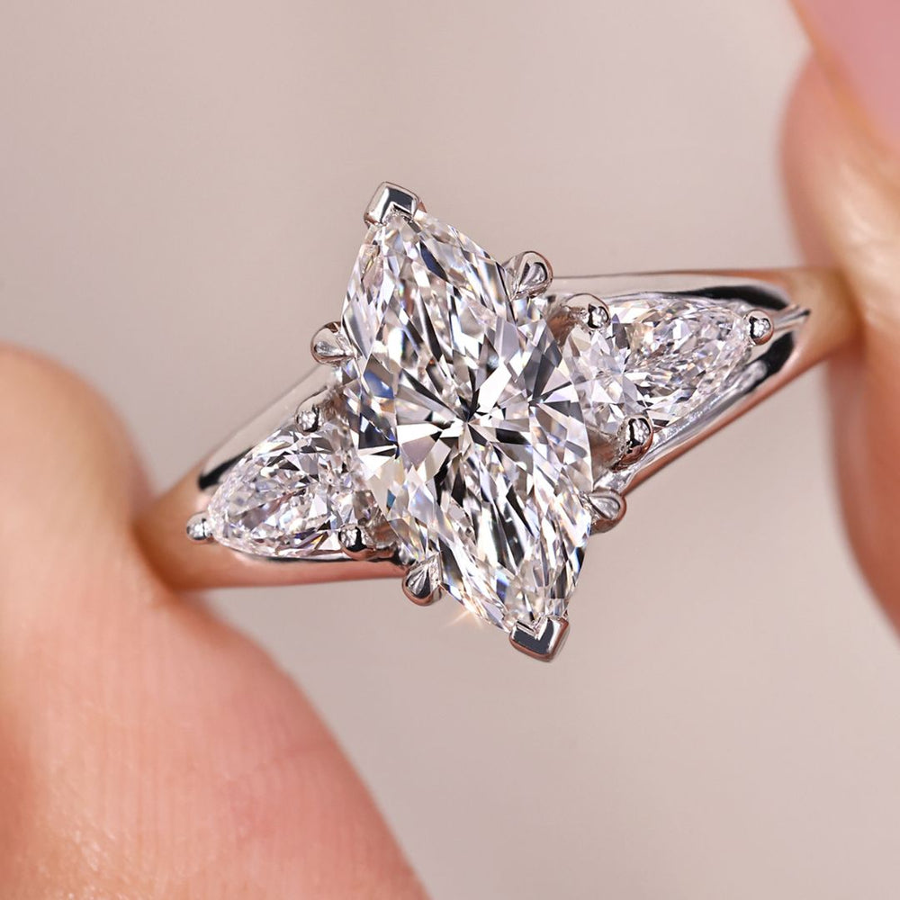 Marquise diamond ring with pear side stones.