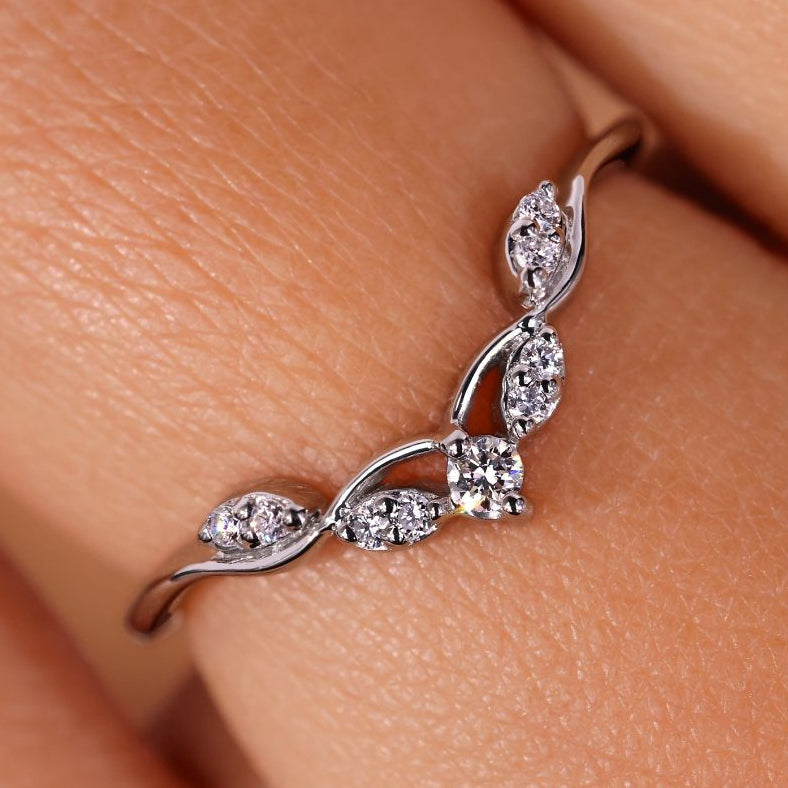 Curved wedding band featuring a marquise diamond wedding band design.

