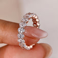 A stunning oval diamond eternity band with a sleek design, perfect for a timeless wedding look.
