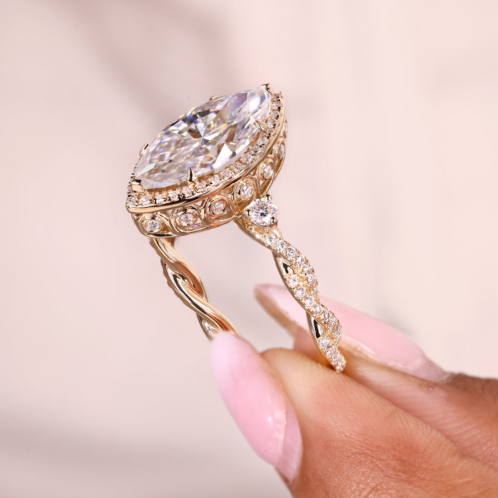 Vintage engagement ring with marquise cut moissanite halo.