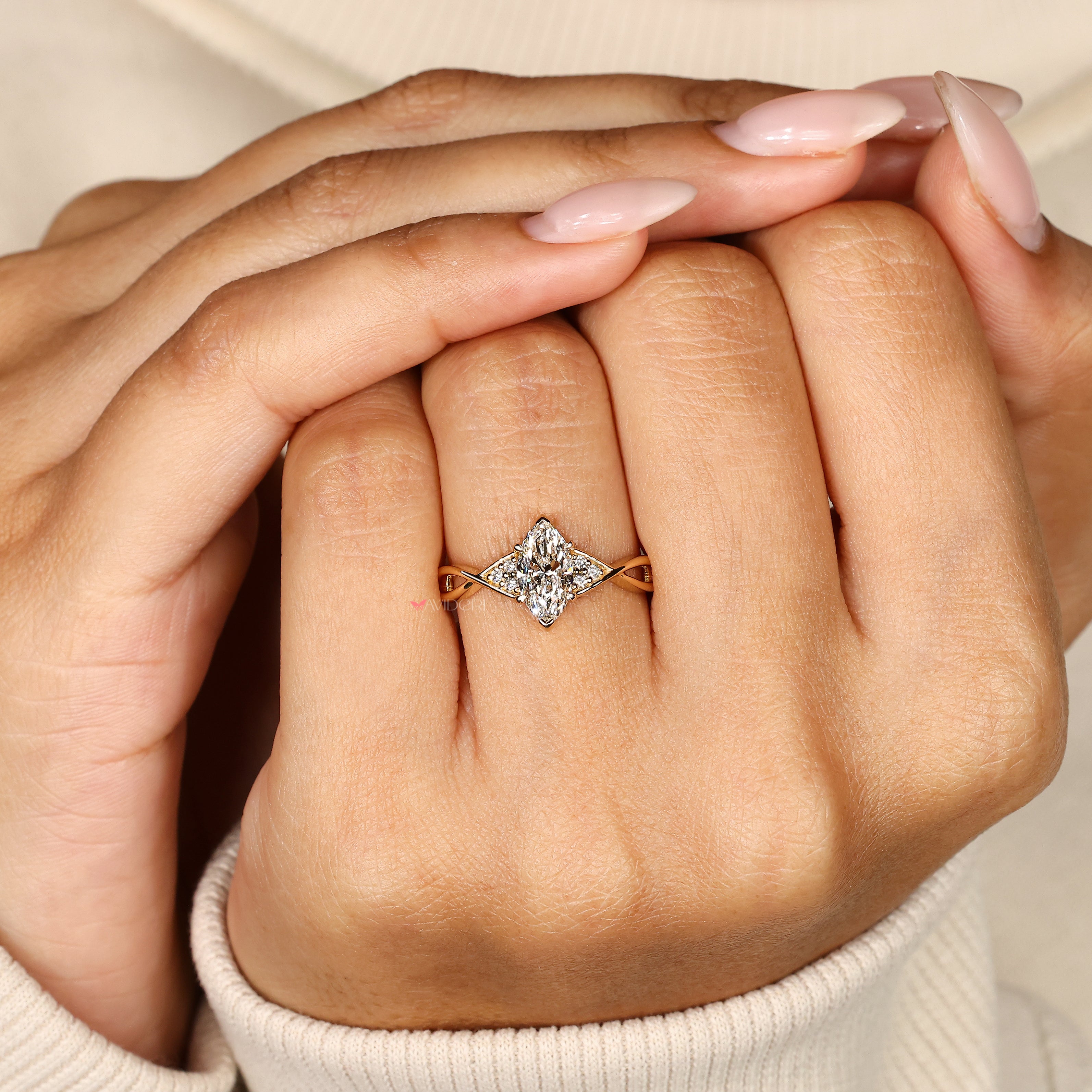 Handmade marquise ring with round diamond side stones.
