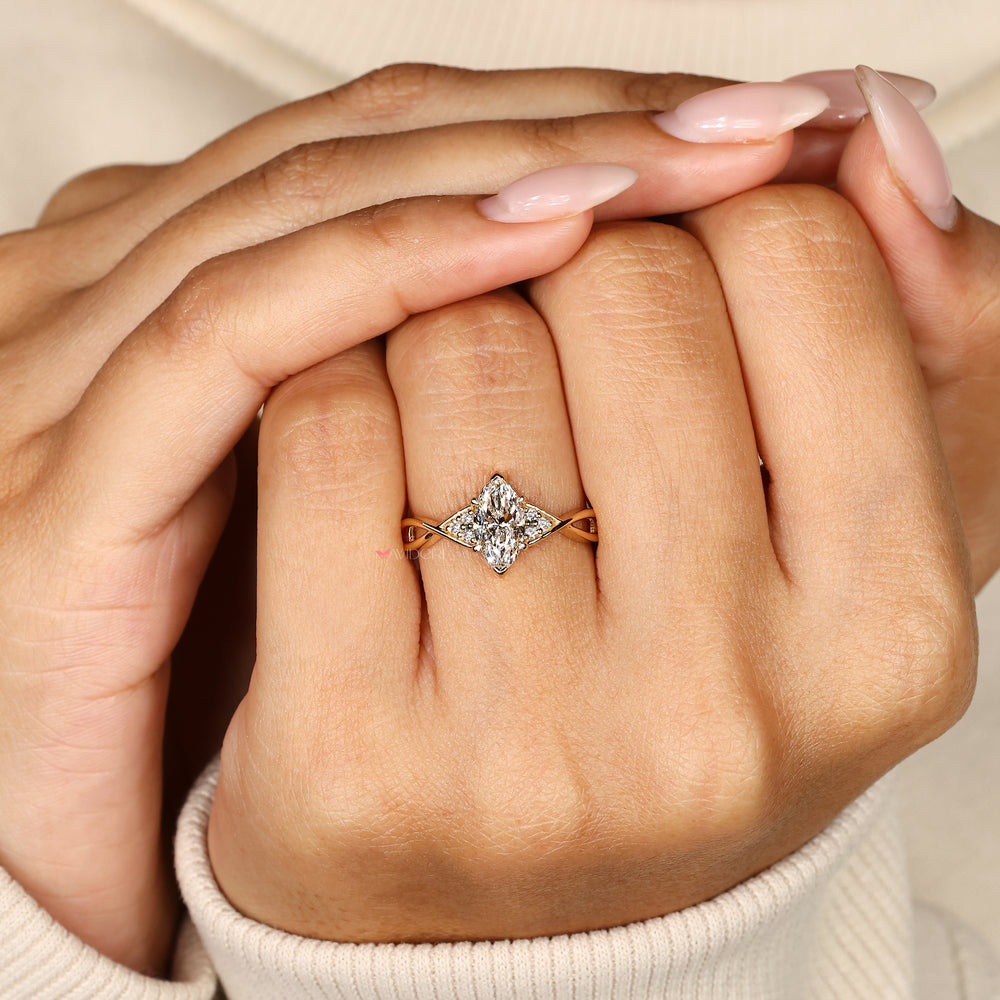 Handmade marquise ring with round diamond side stones.
