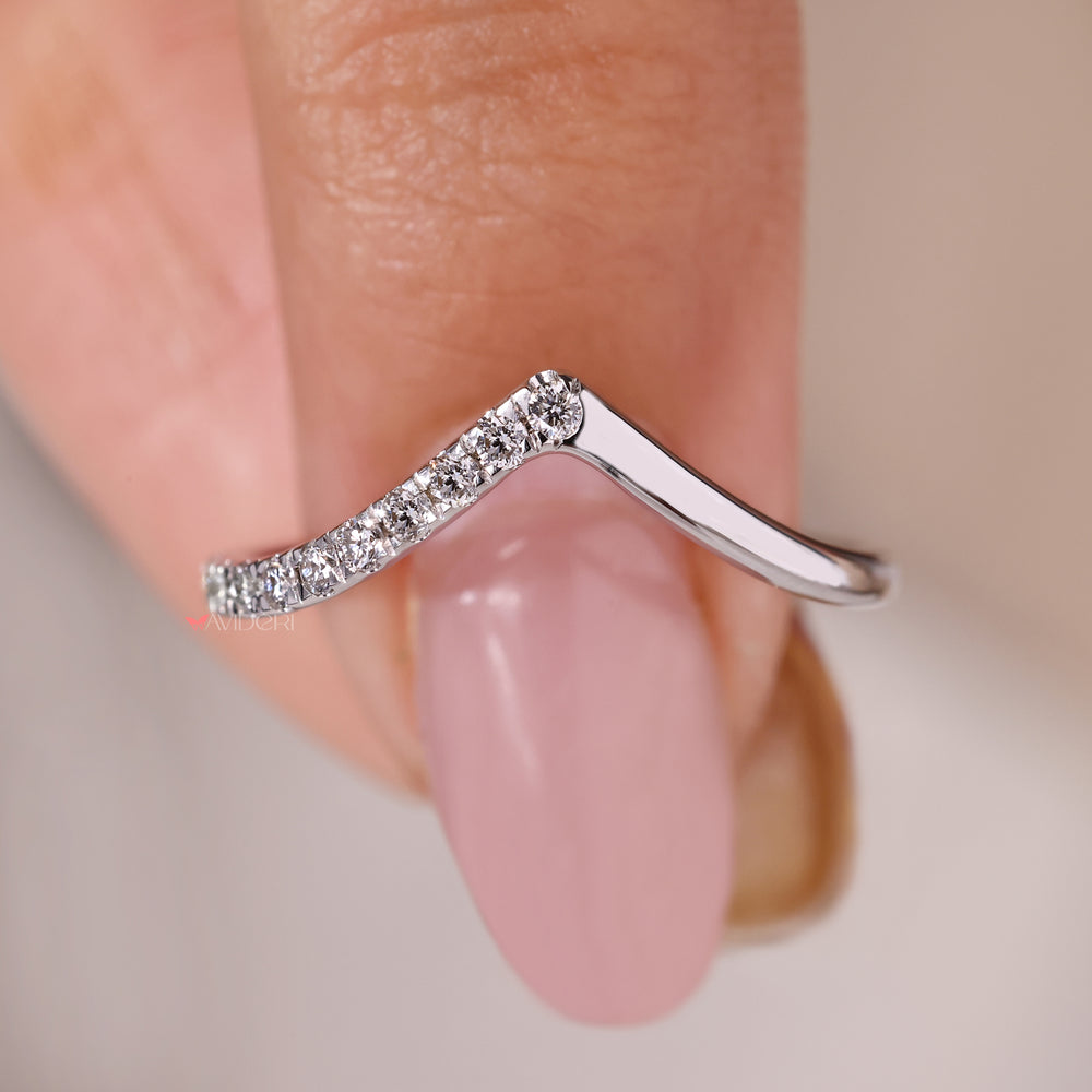 Handmade jewelry with a round curved wedding band and round diamonds.