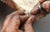 Avideri Jeweller using a handheld tool to set a gemstone in a ring during the crafting process.