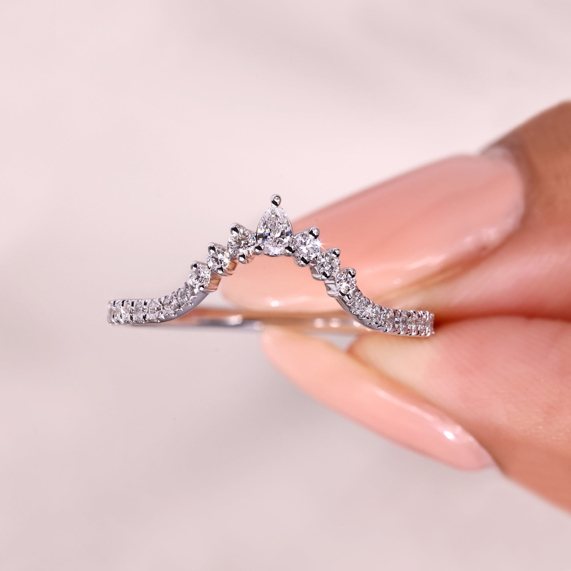 Handmade pear and round diamond chevron ring.
