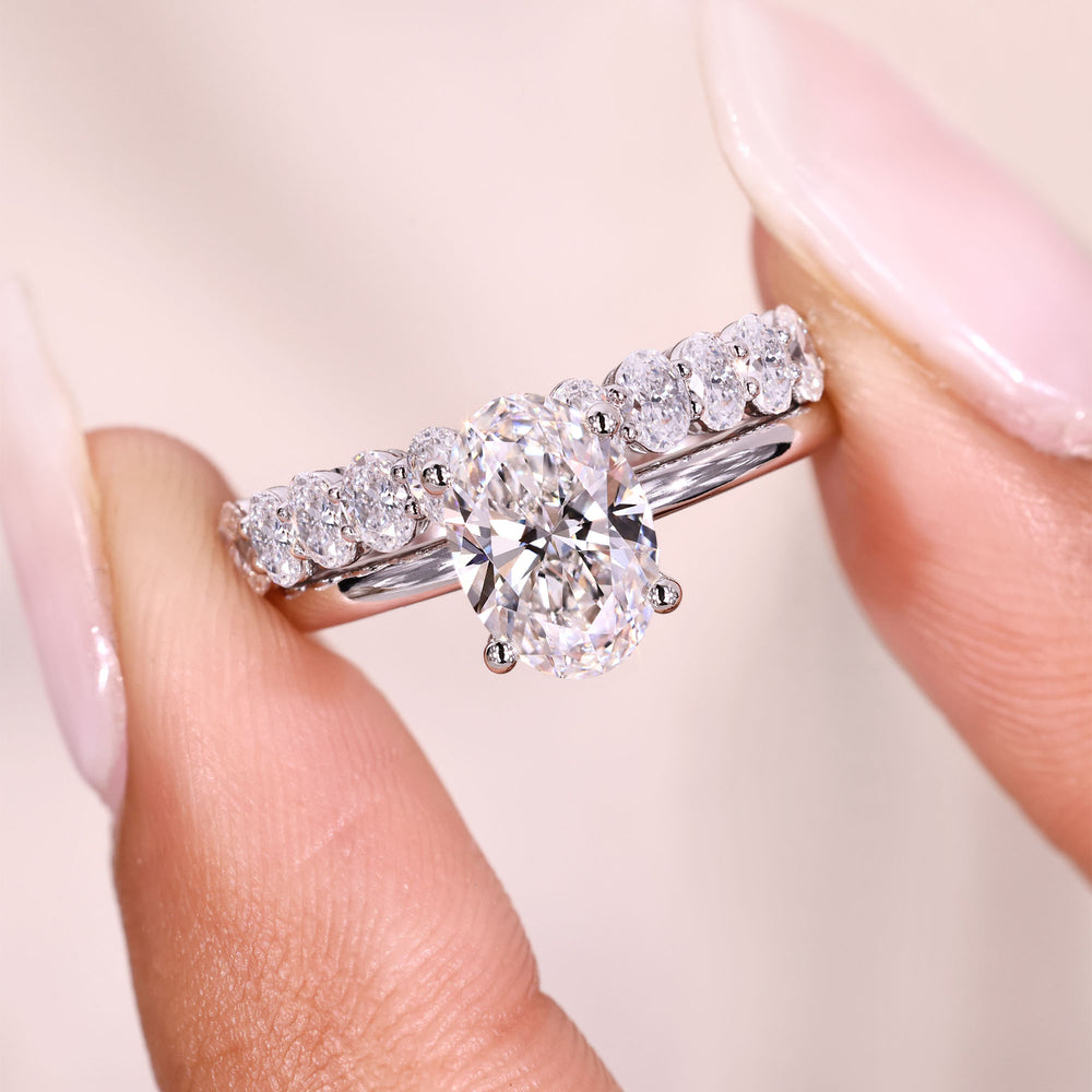Bridal set with shared prong oval diamond band.
