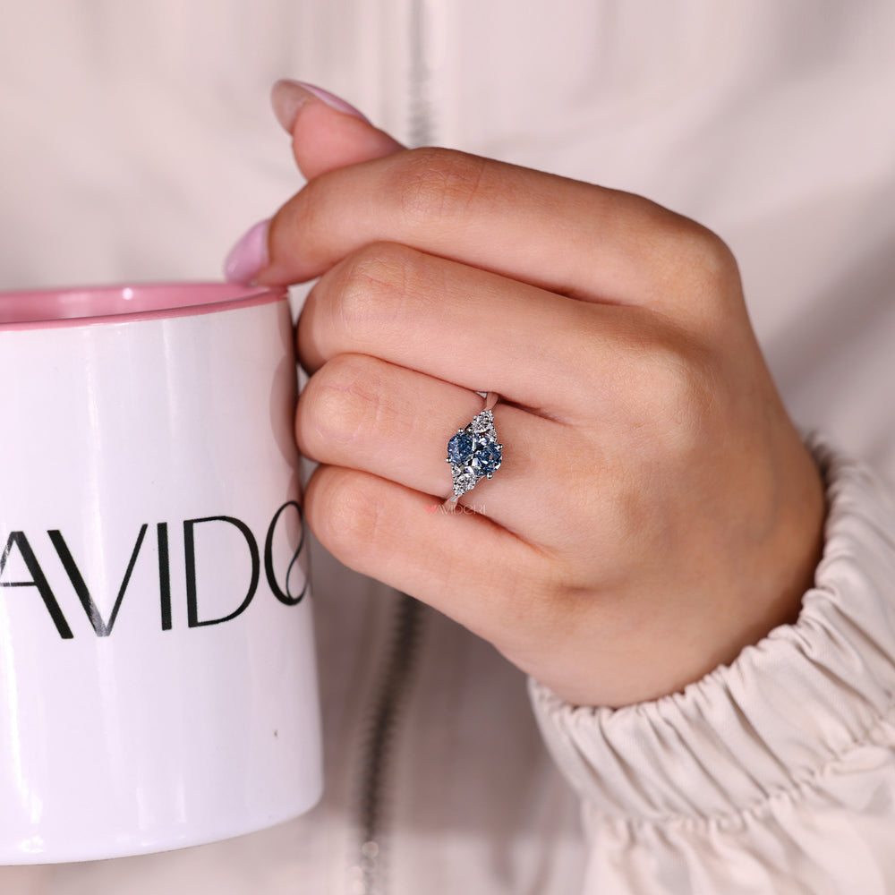 Oval ring with basket setting and side stones.
