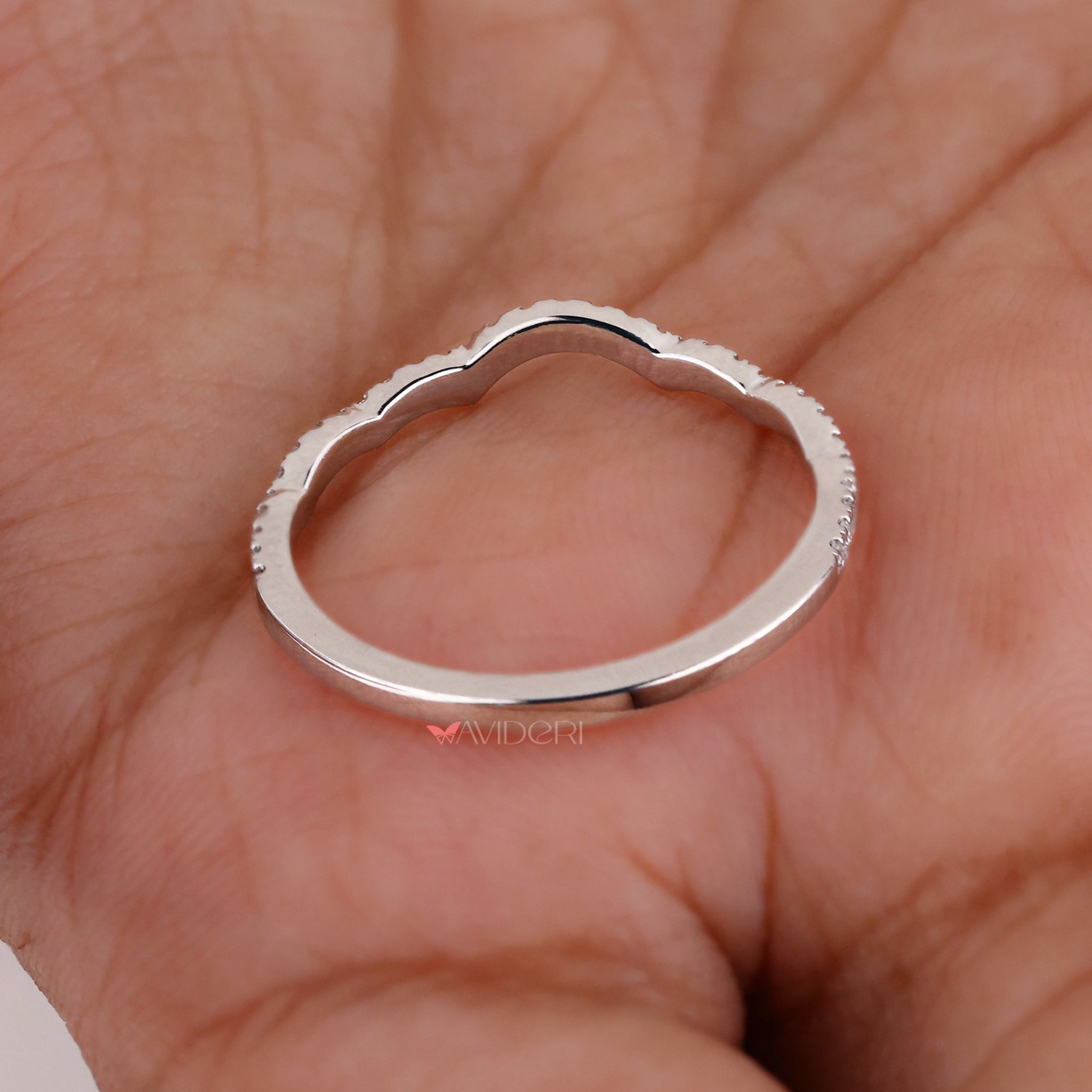 Curvy wedding band with a unique, flowing design.
