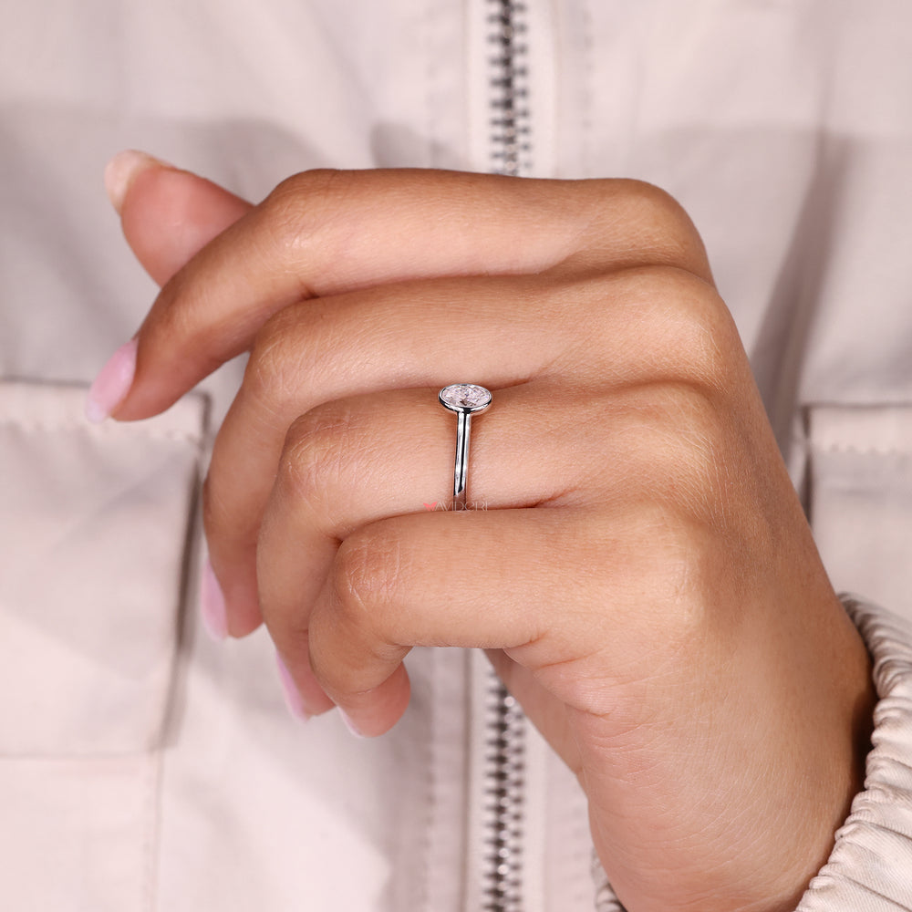 A bezel set engagement ring​ provides clean lines and secure brilliance.