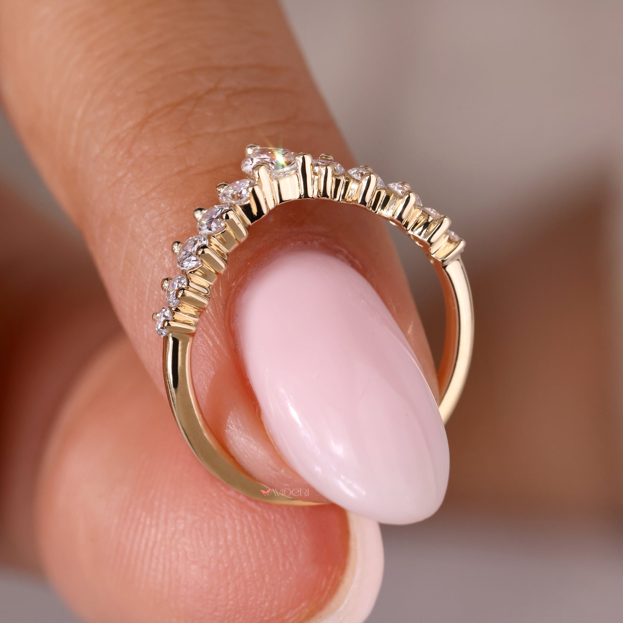 Yellow gold wedding band featuring a pear shaped diamond design.
