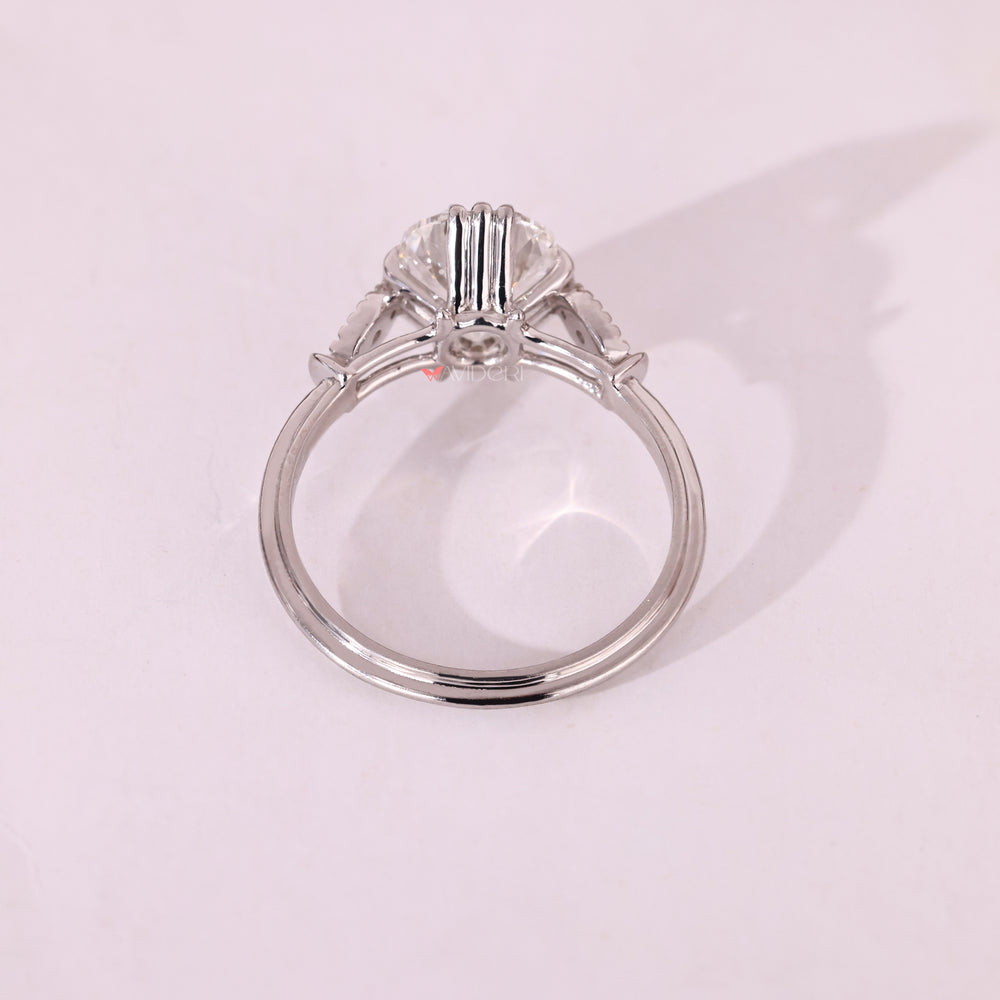 White gold engagement ring with cushion Old European Cut diamond and seven stone setting.