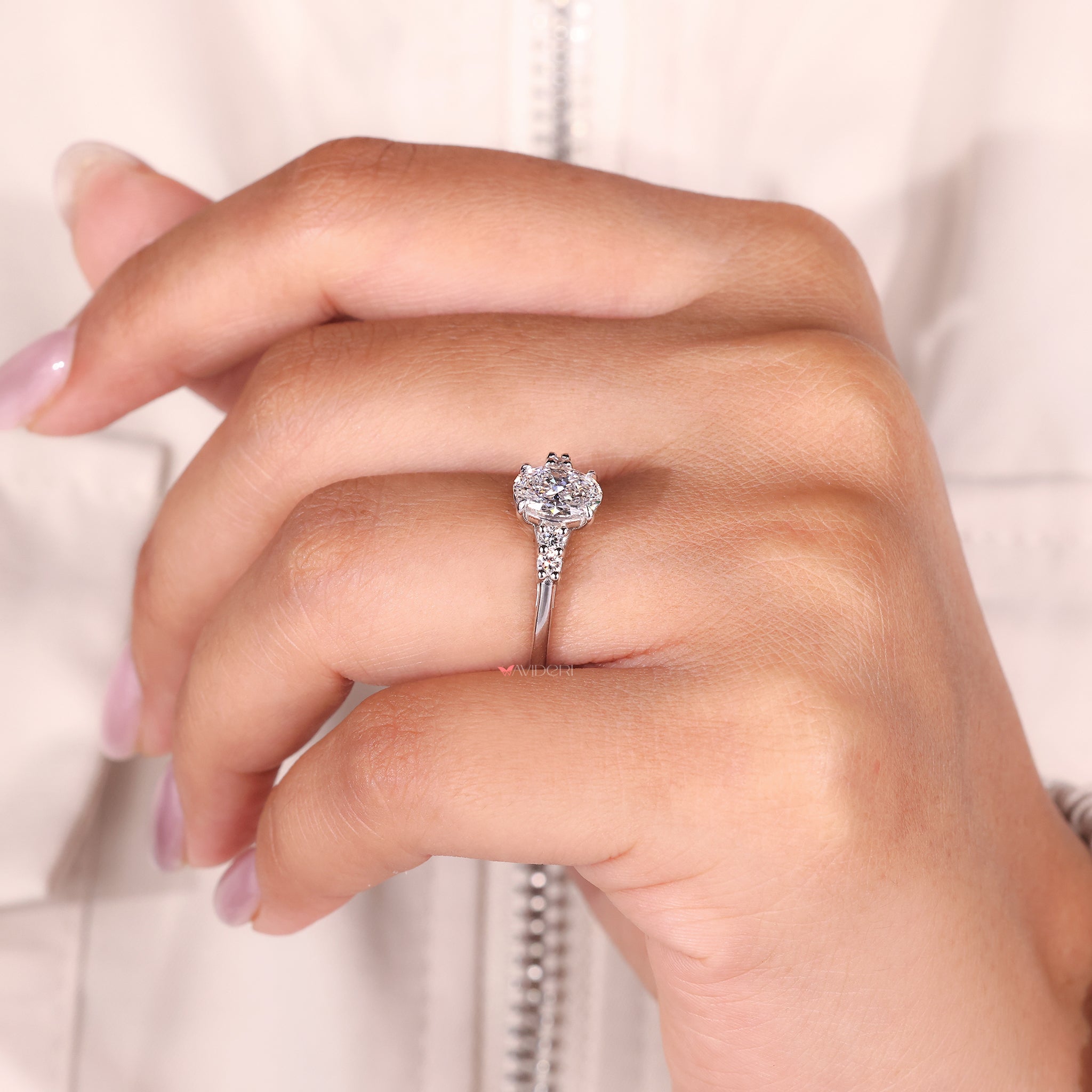 White gold engagement ring with side diamonds and leaf accents is a meaningful gift for her.

