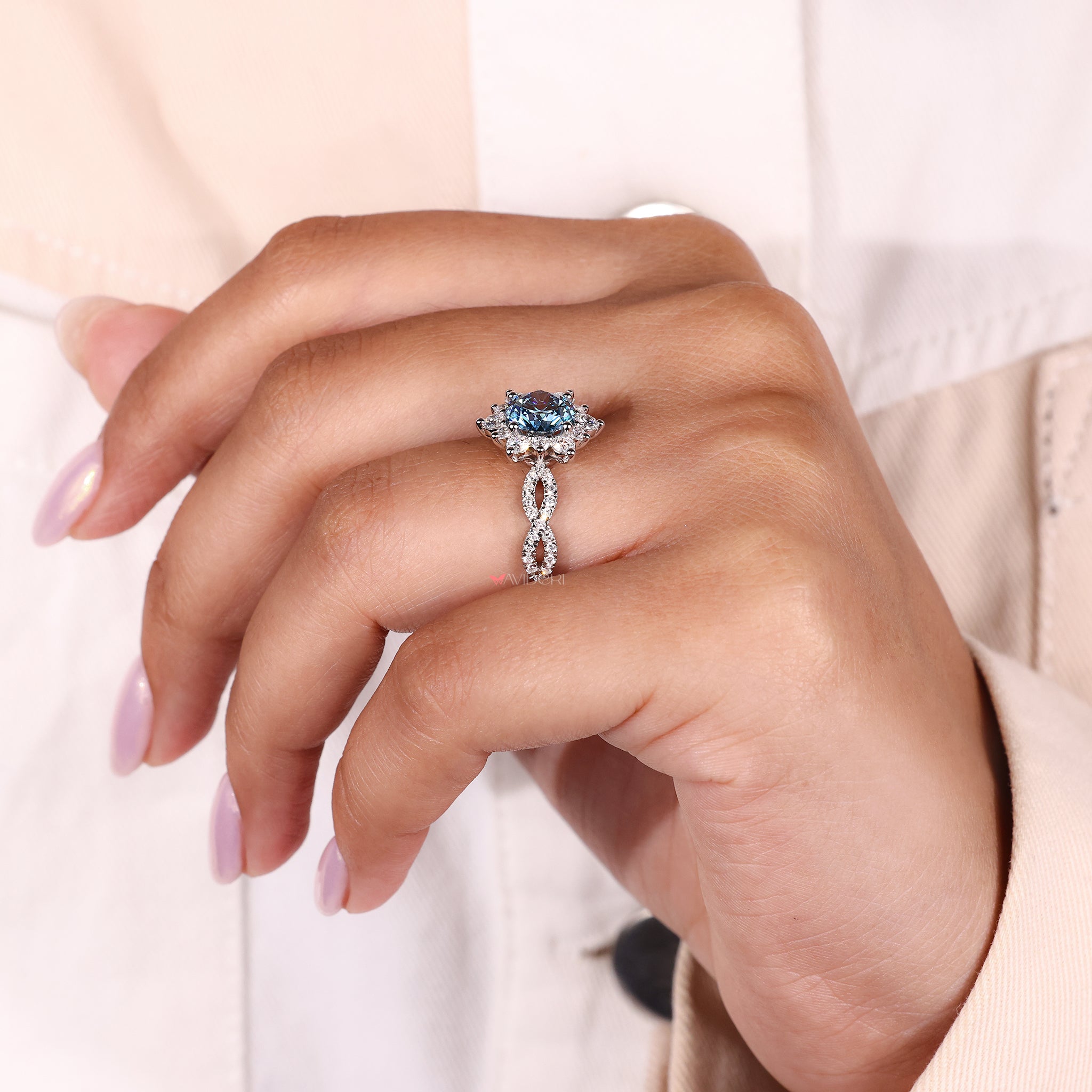 avideri engagement ring with round blue diamond and cluster design.