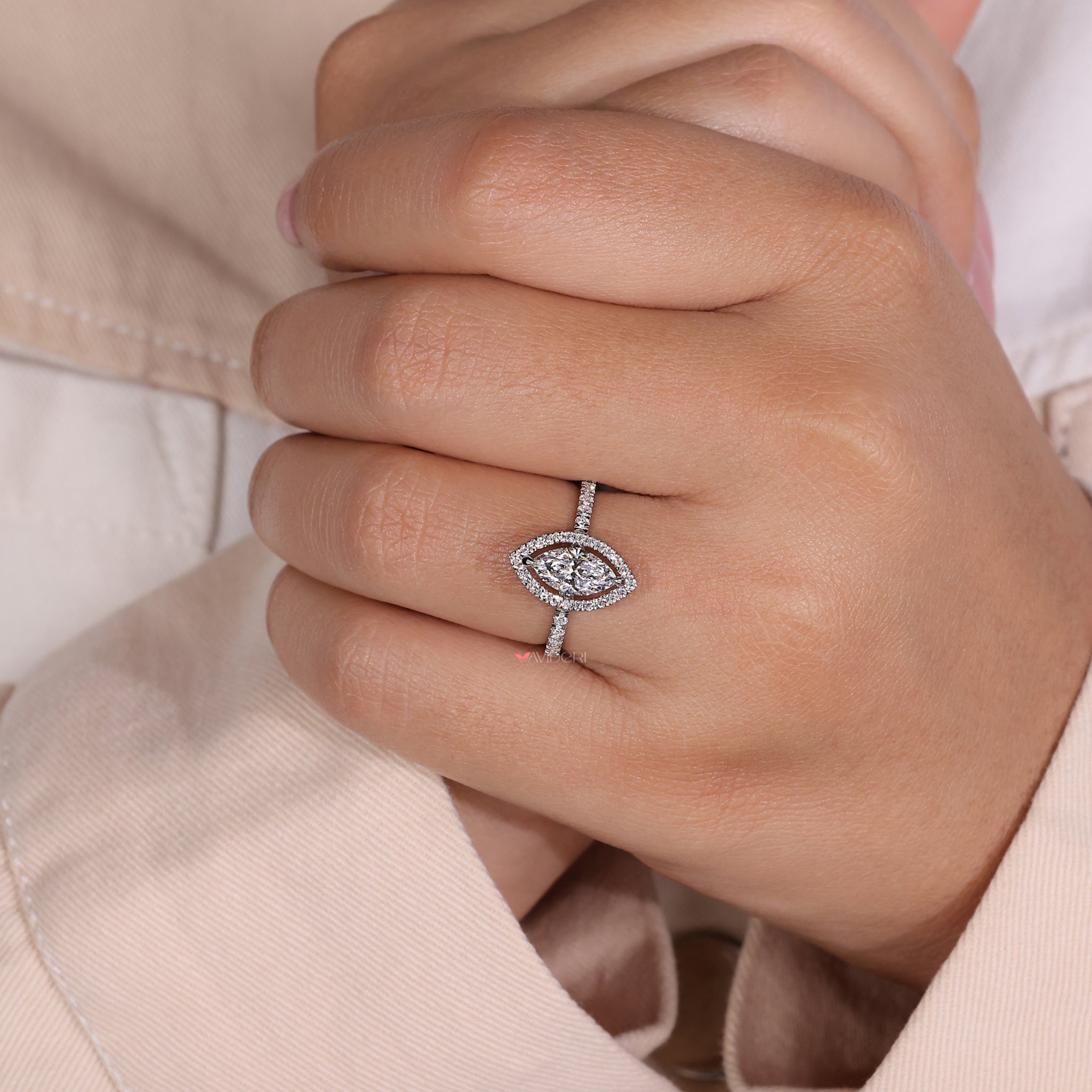 Halo marquise diamond with pave set stones, combining modern design and classic elegance for a unique engagement ring.
