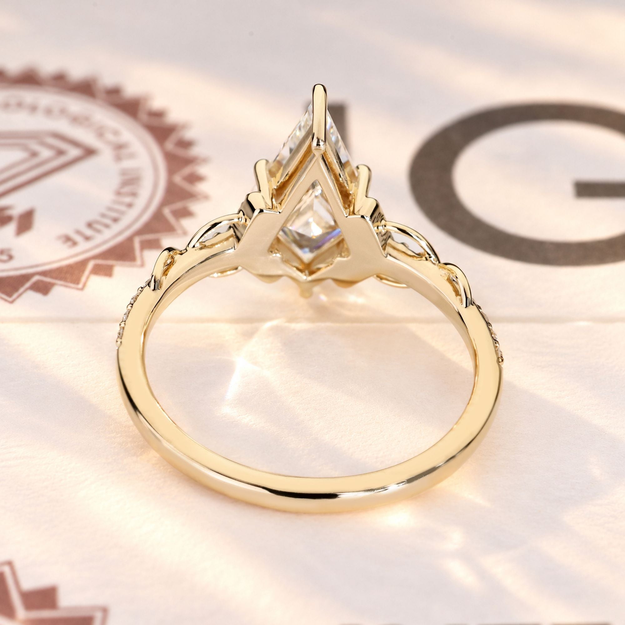 IGI certified kite cut diamond ring with vine detail.
