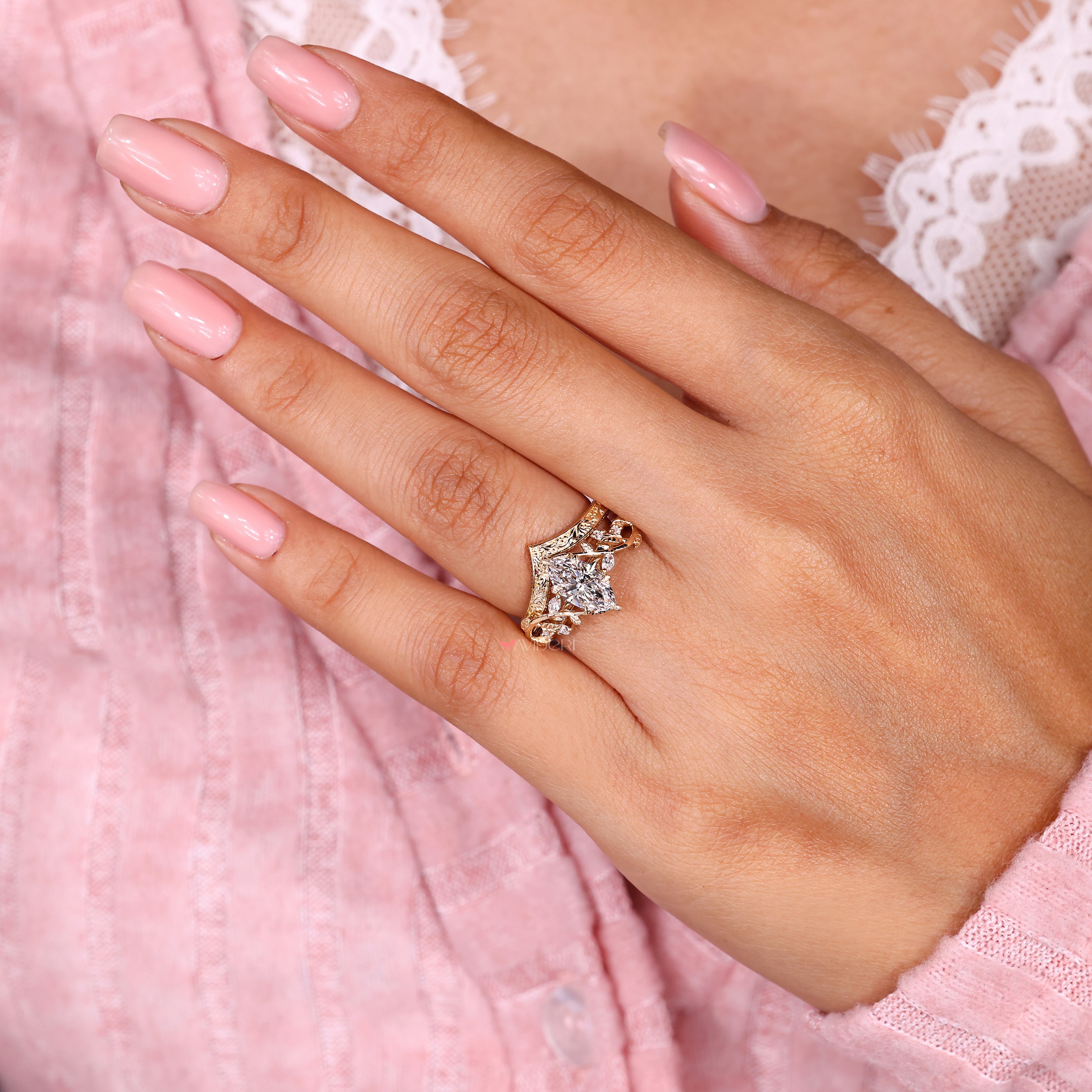 Marquise engagement ring with round accents and V band
