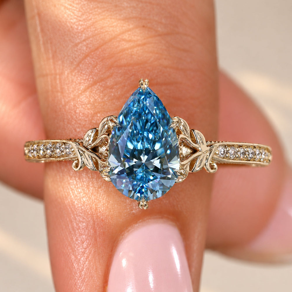 Pear cut diamond ring with blue diamond centre stone.
