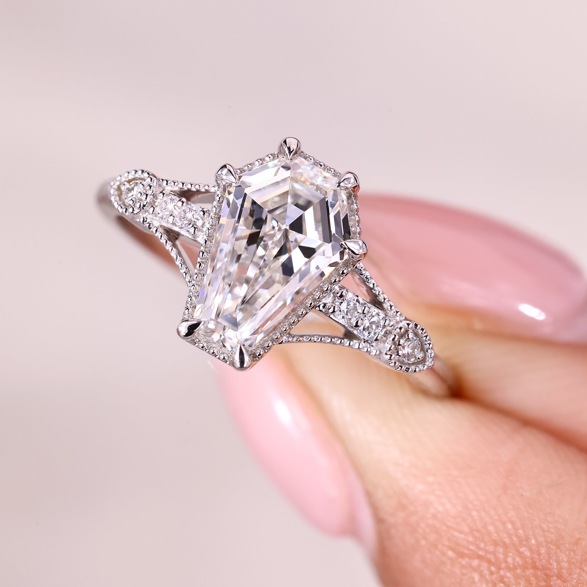 Coffin cut engagement ring with six claw prong setting.