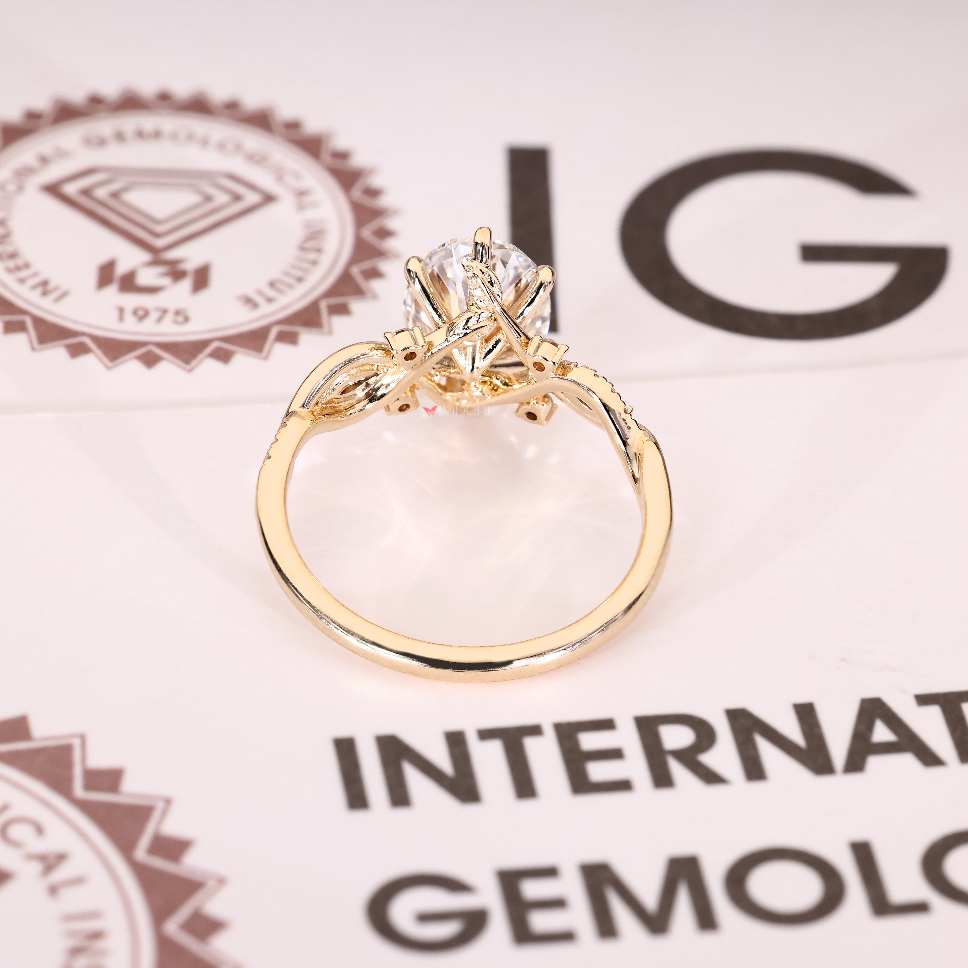 Oval engagement ring with pavé band and marquise side stones
