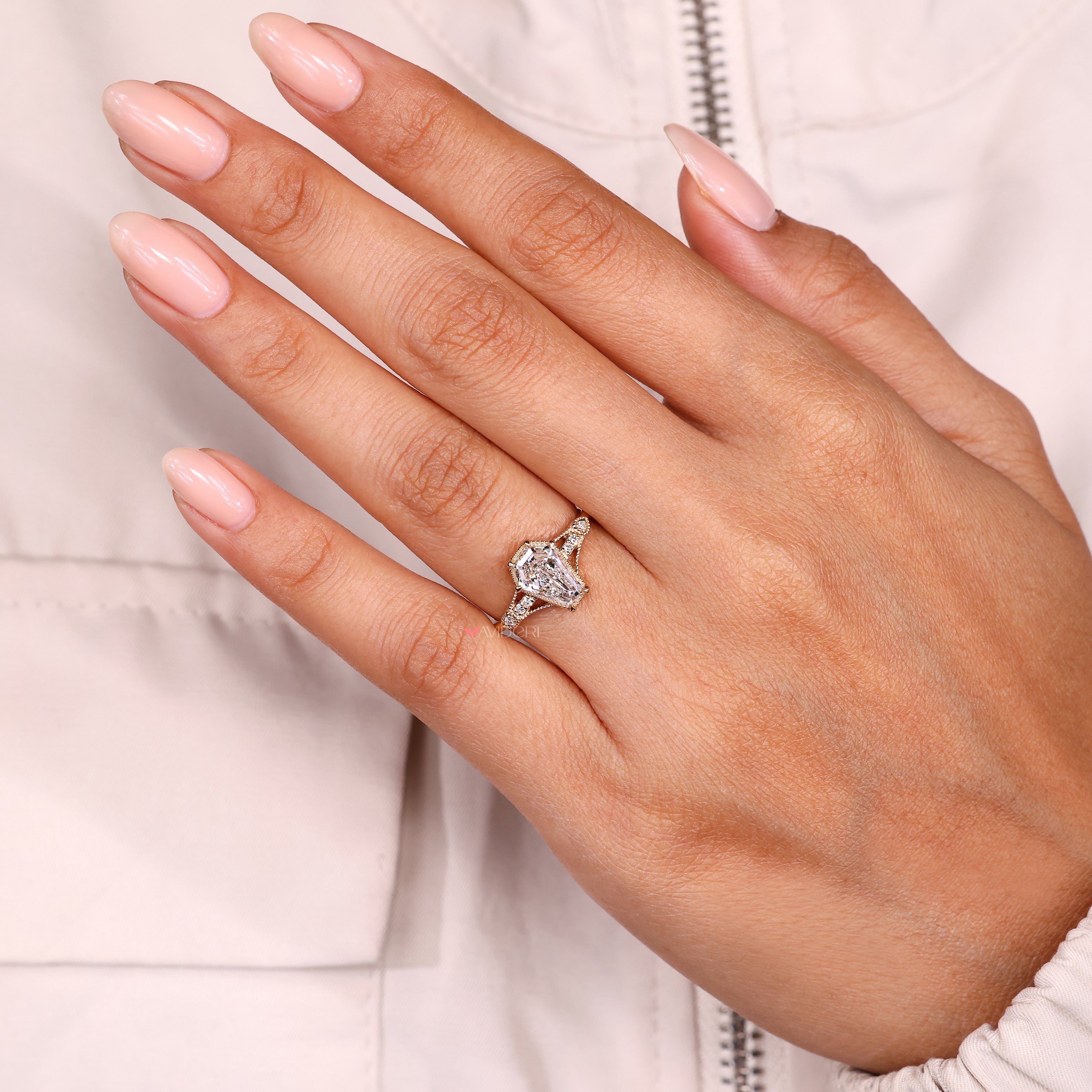Handmade shield cut diamond ring with claw prong setting.
