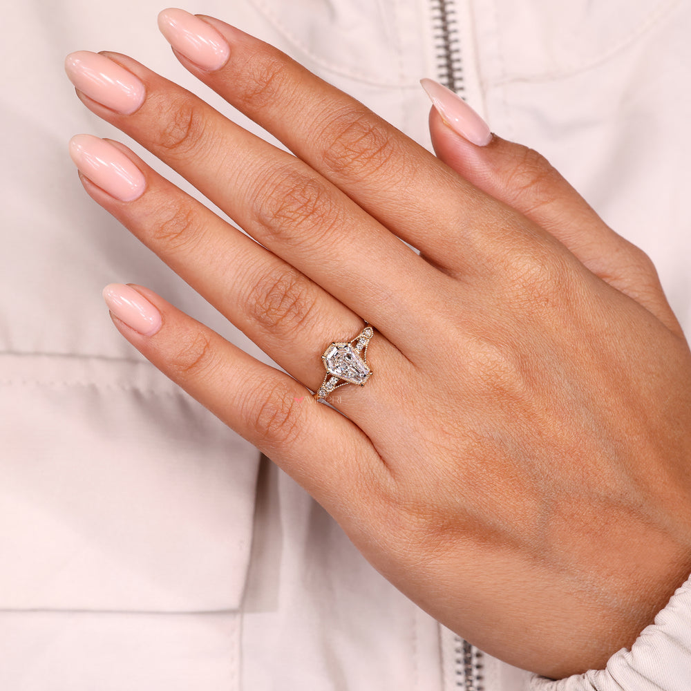 Handmade shield cut diamond ring with claw prong setting.
