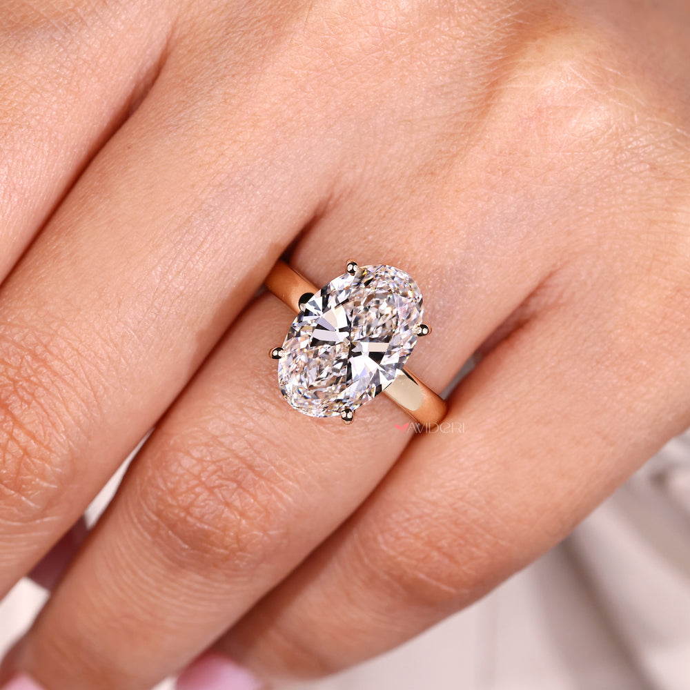 Oval diamond ring with round hidden halo accents.
