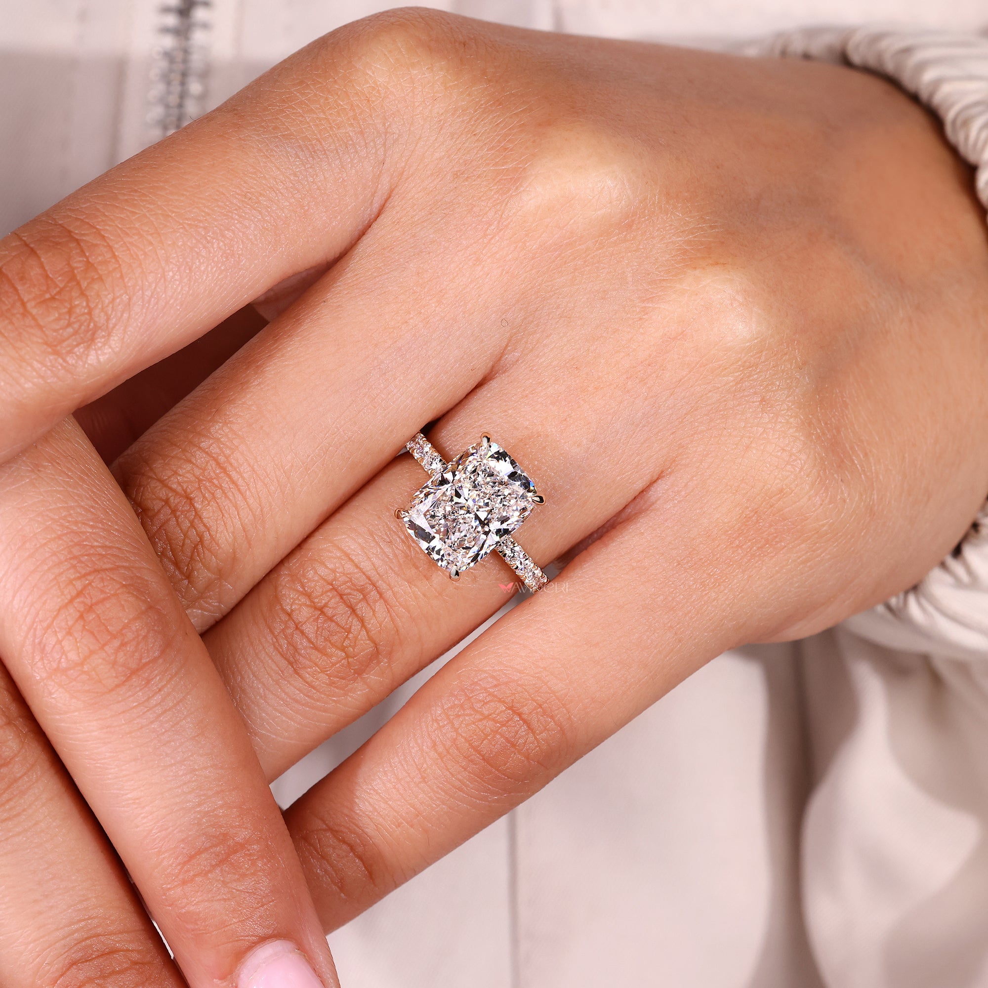 Cushion cut lab grown diamond ring with four prong setting.
