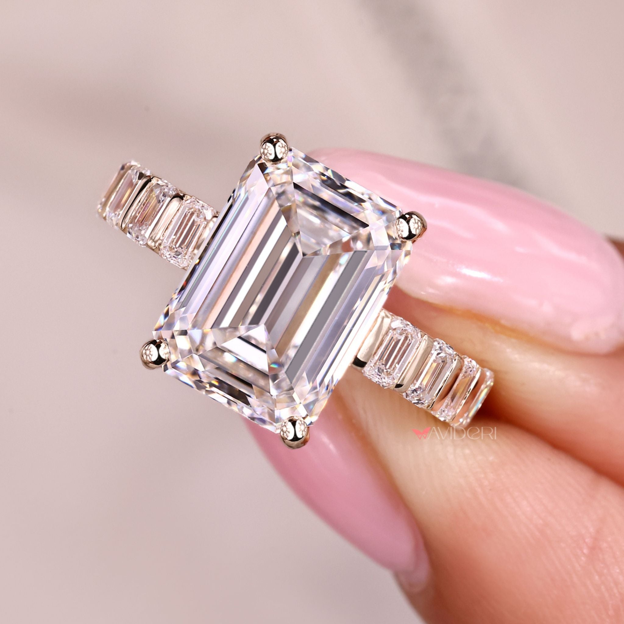 Emerald cut diamond ring with sleek bar setting.
