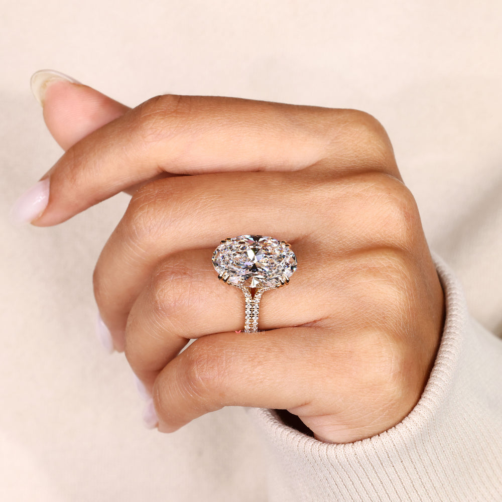 Cathedral oval ring with round diamond pave band.
