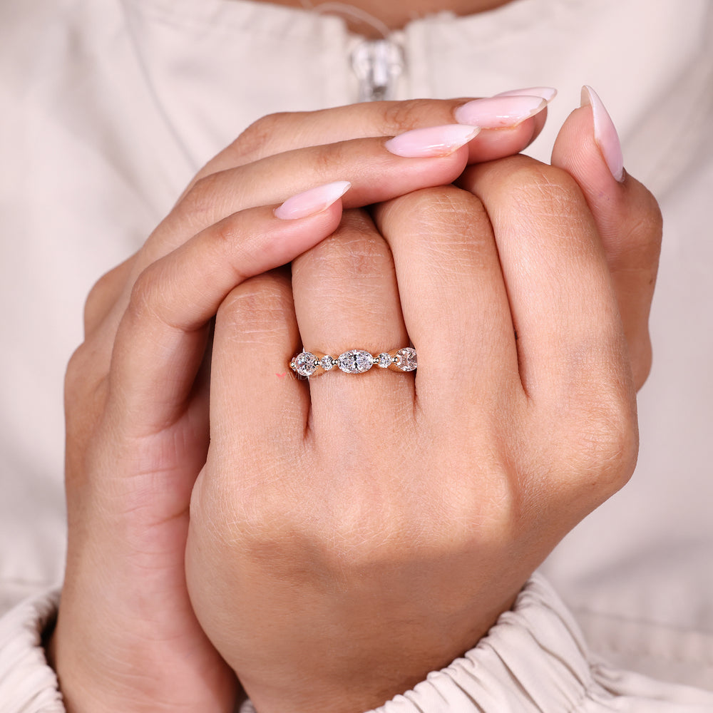 Wedding band with oval and round diamonds design.
