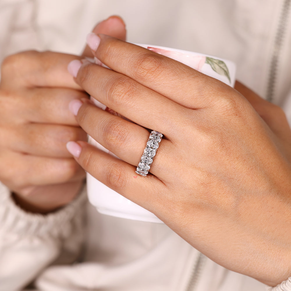 Oval band with round diamond pave style design.
