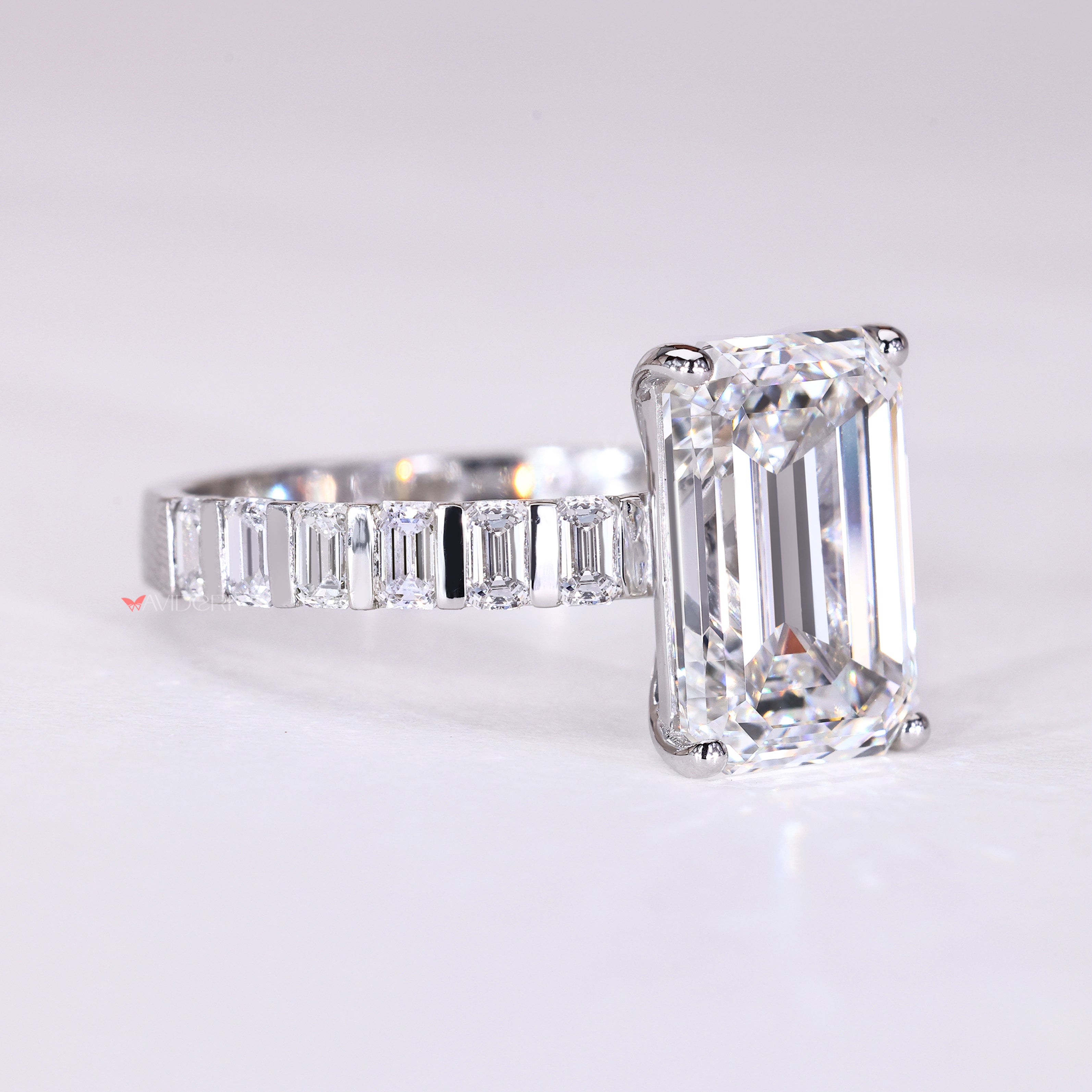 Emerald cut engagement ring with bar set emerald diamonds
