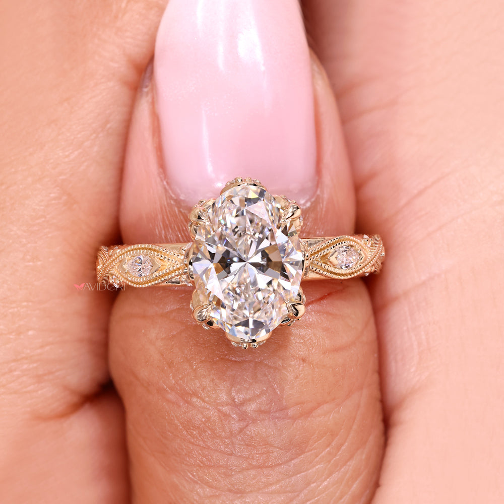 Oval diamond ring with marquise side stones.
