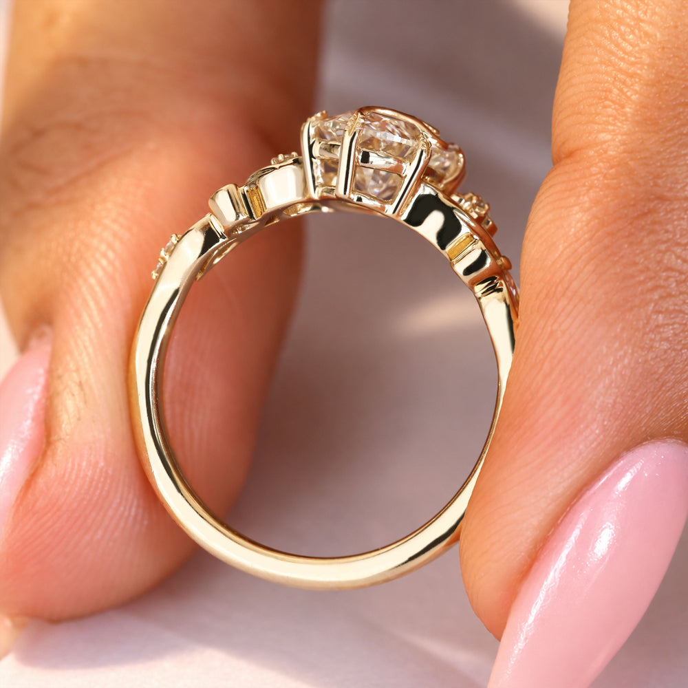 Oval diamond ring with six leaf style prongs.
