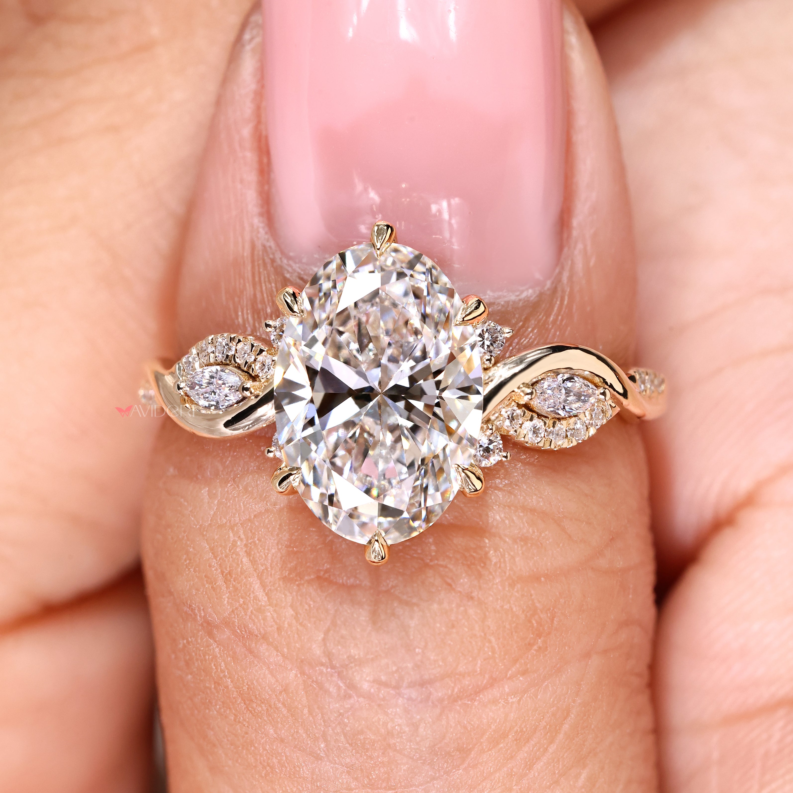 Avideri oval diamond ring with marquise side stone design
