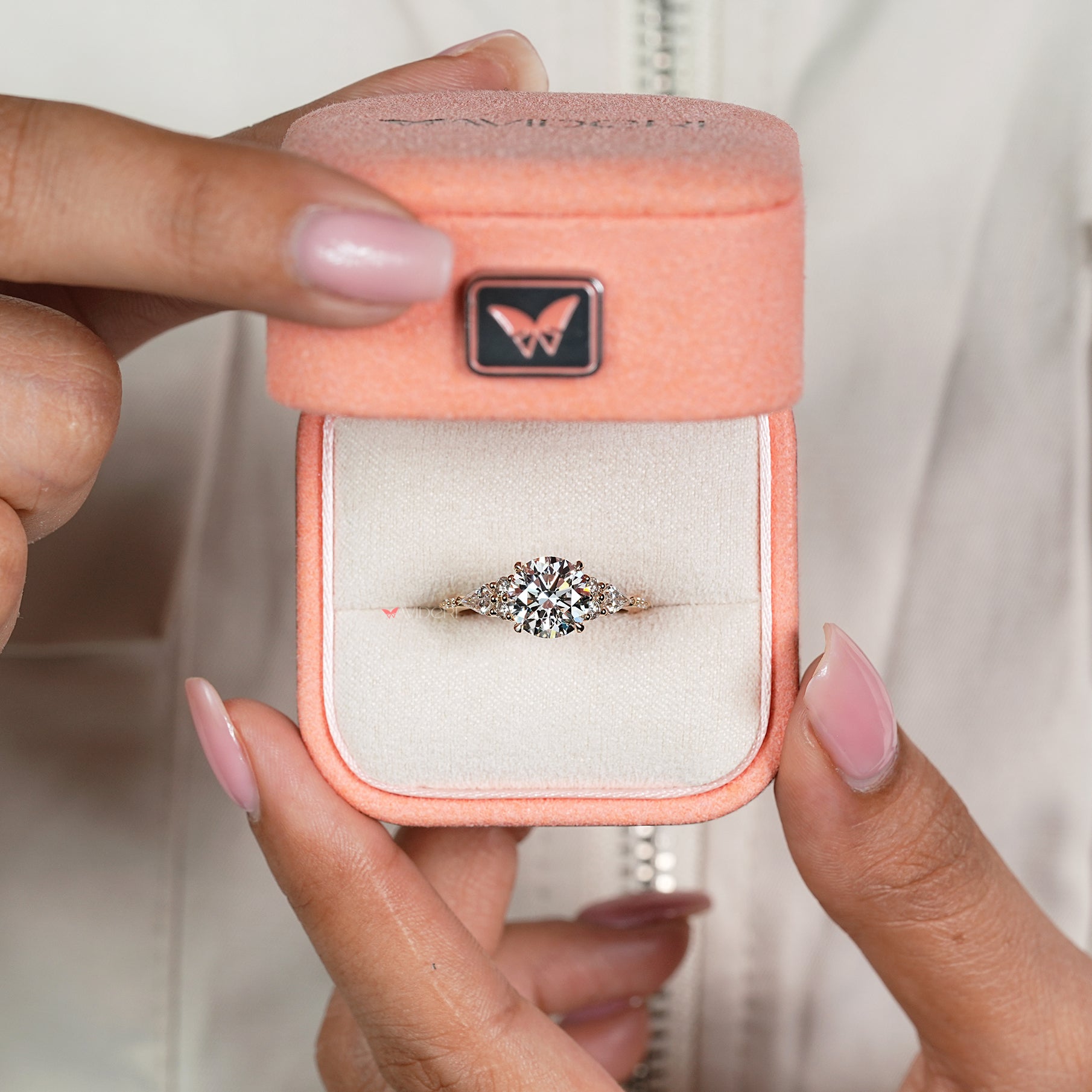 Handmade round diamond ring with kite side stone accents
