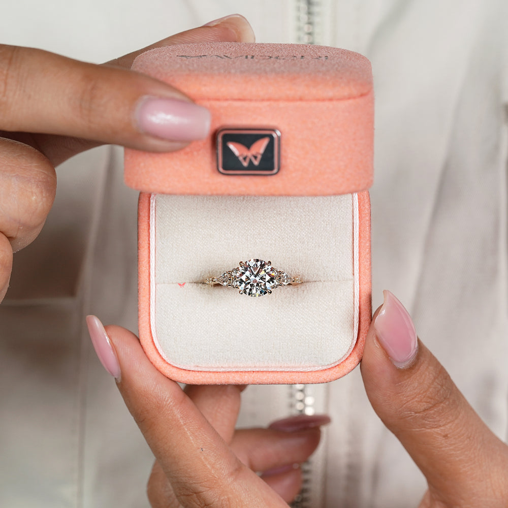 Handmade round diamond ring with kite side stone accents
