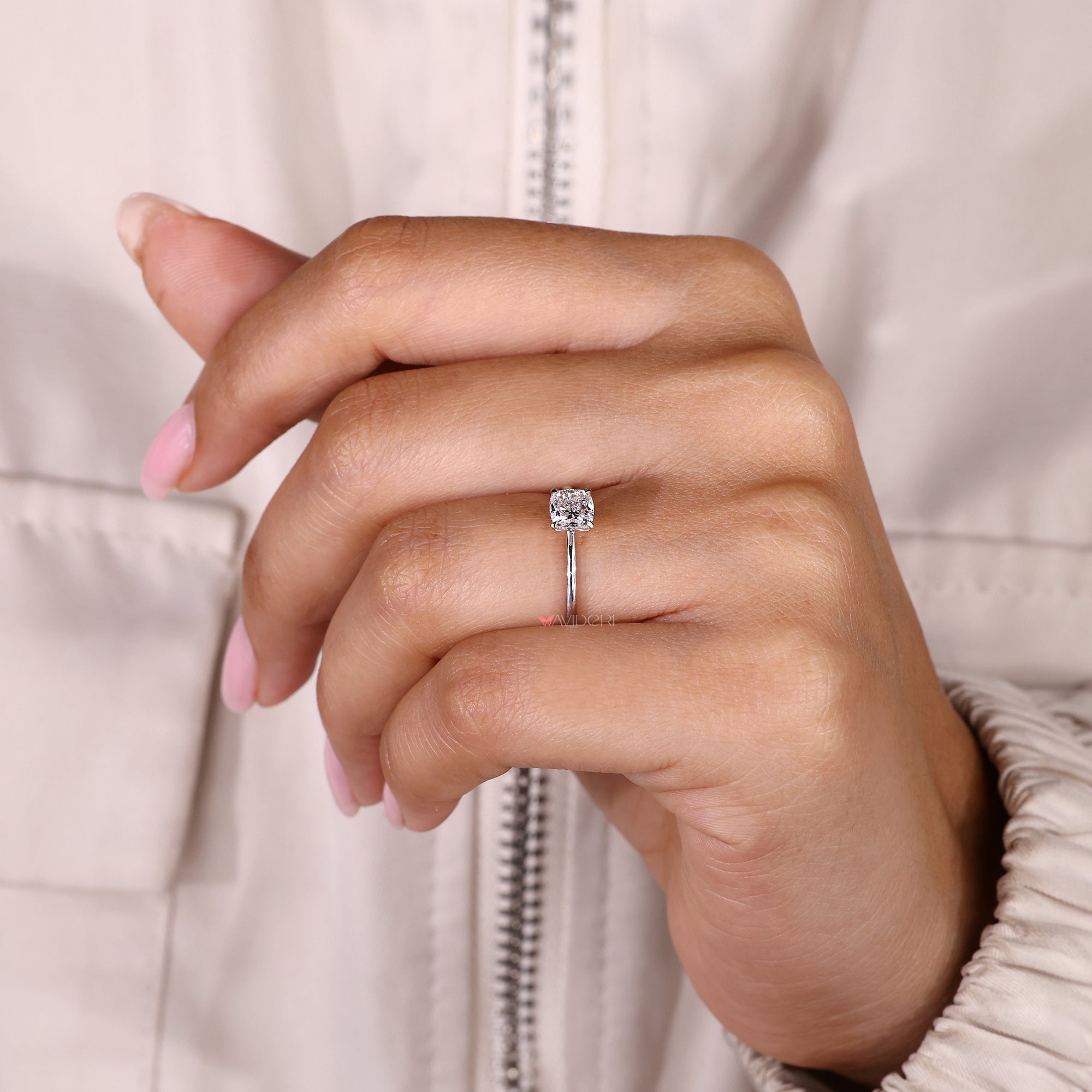 IGI certified cushion cut diamond ring with prong setting.