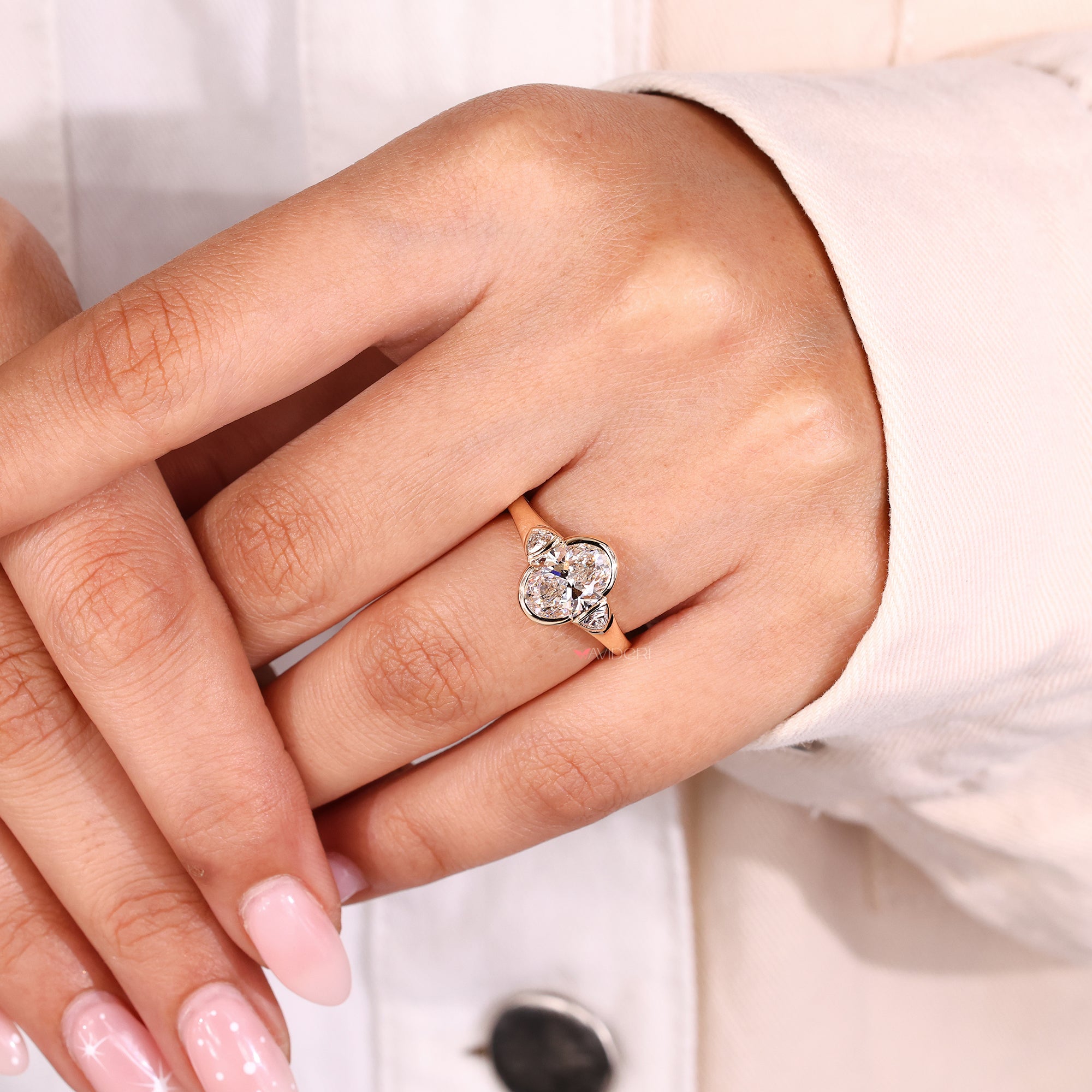 3 stone engagement ring in a half bezel setting.