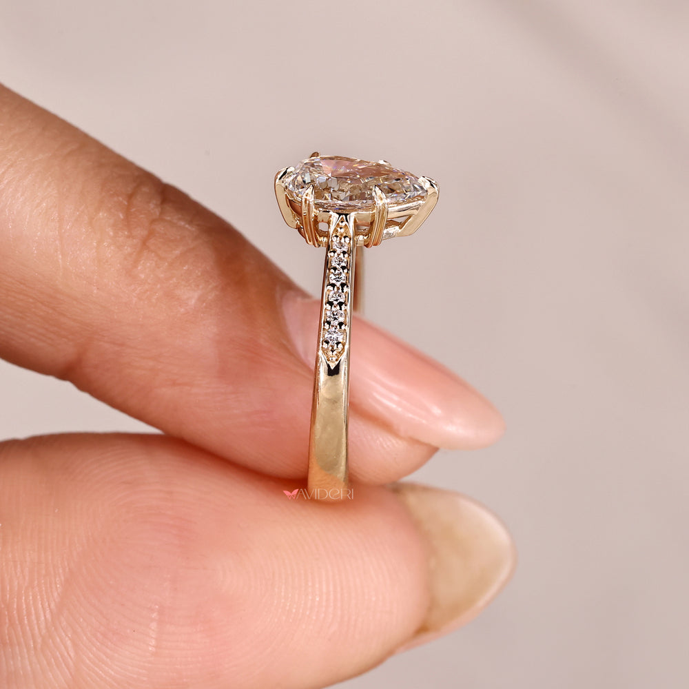 Pear diamond ring with round pave band.

