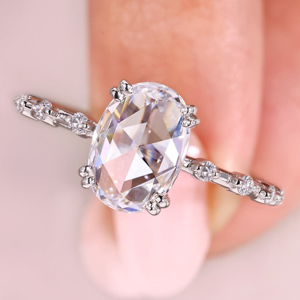 Oval rose cut engagement ring with round cut side stones.