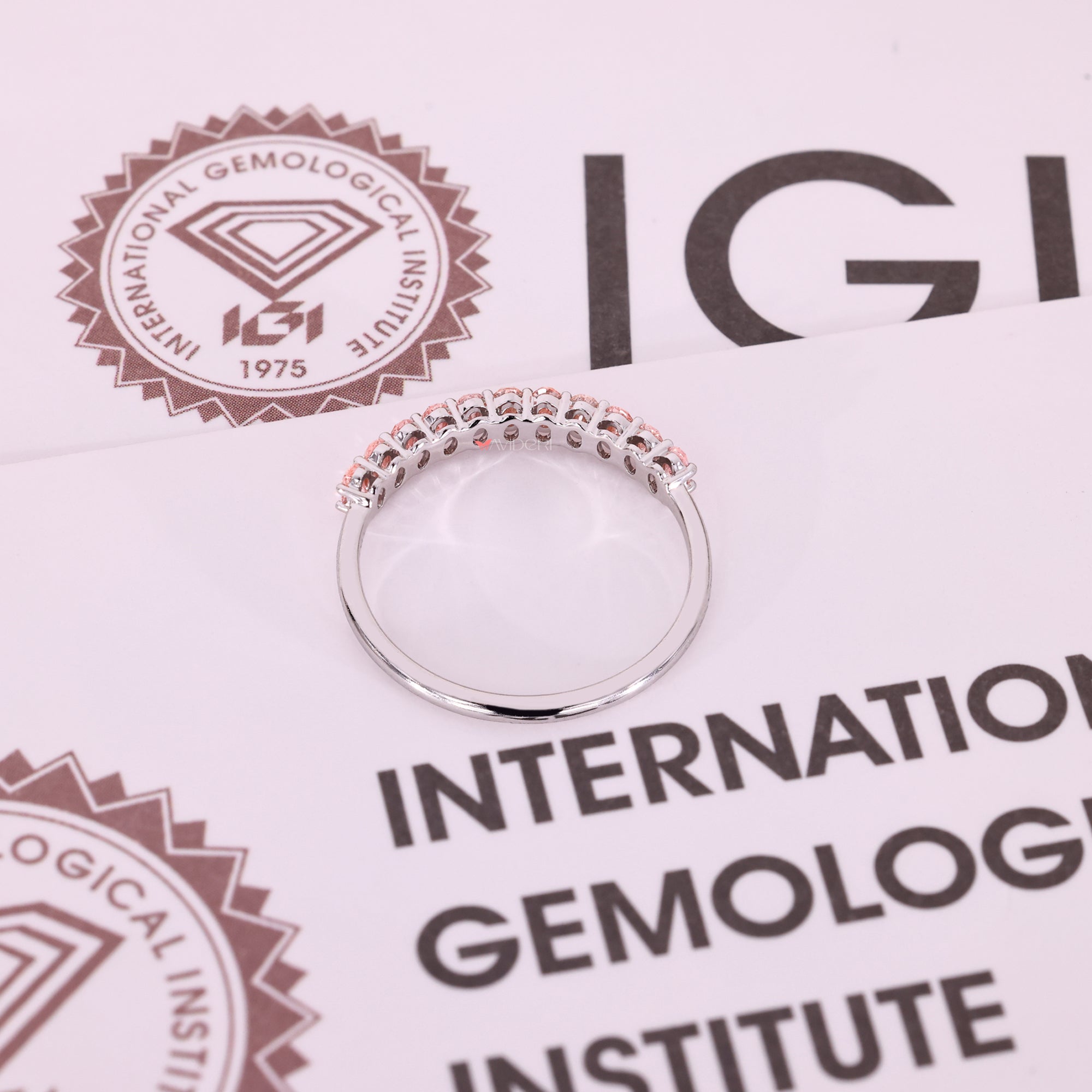 White gold wedding band with oval shaped diamonds in shared prong style.