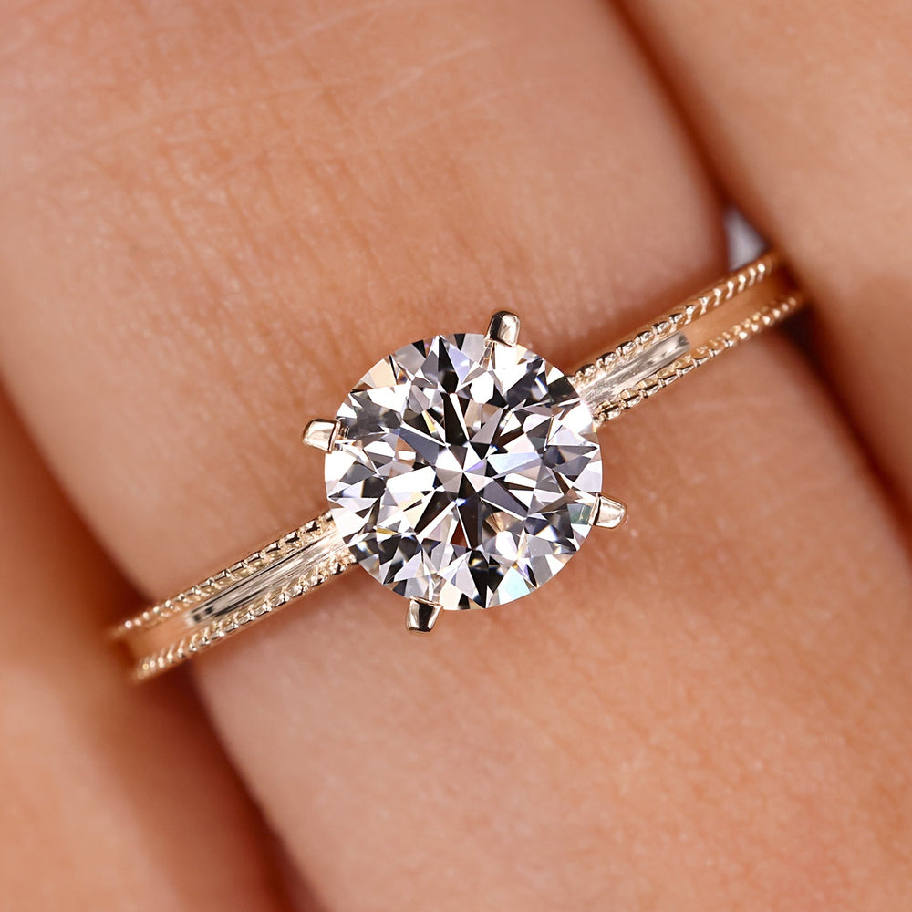 Round diamond engagement ring in yellow gold.
