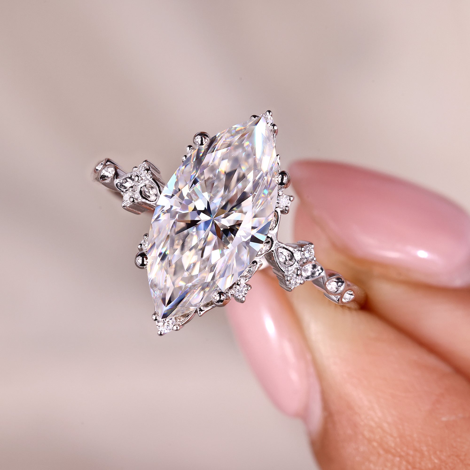 Four prong setting ring holding a bright marquise moissanite.