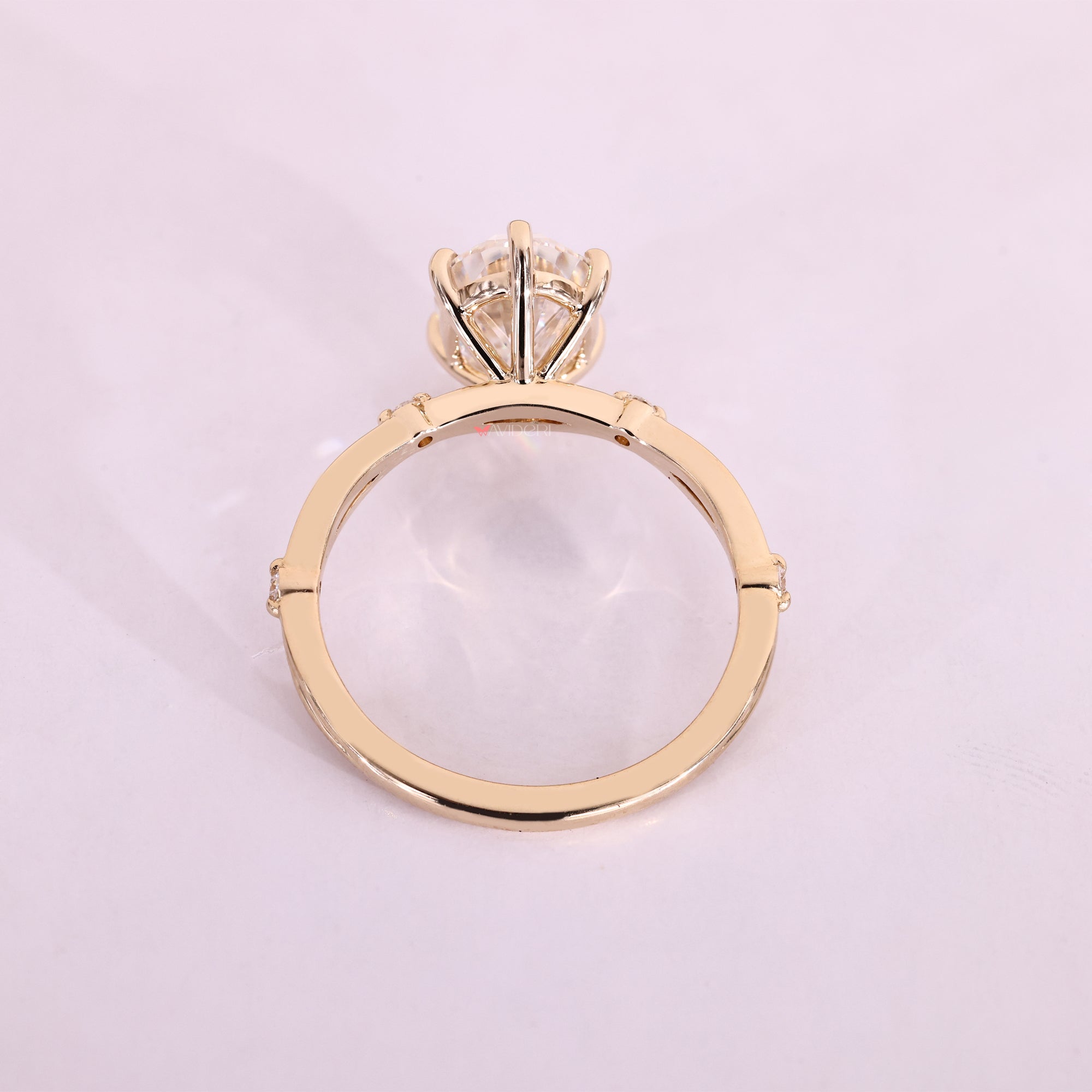 Yellow gold engagement ring featuring a radiant center stone.