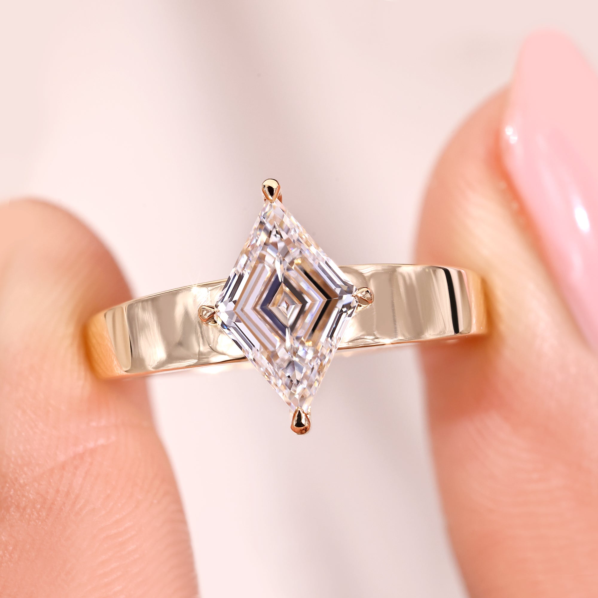 Lozenge cut diamond ring with compass prong ring.