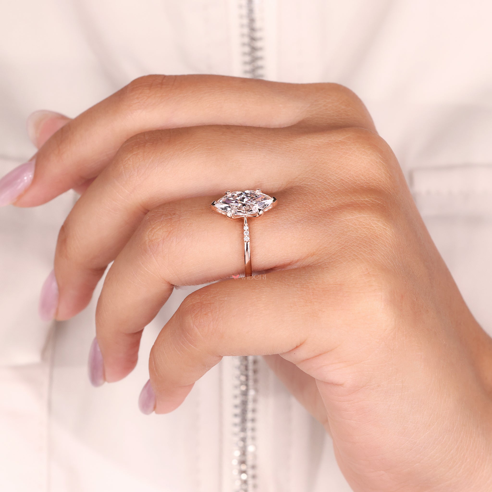 Side diamond ring features handmade tulip setting for added elegance.
