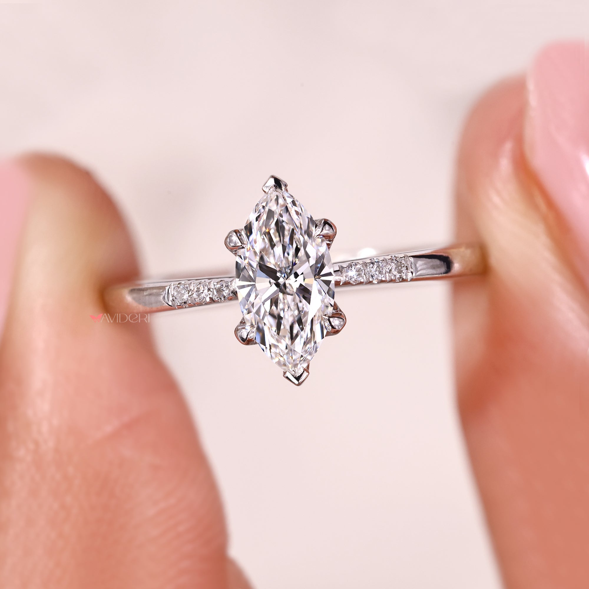 Handmade ring featuring marquise diamond and round cut side stones.